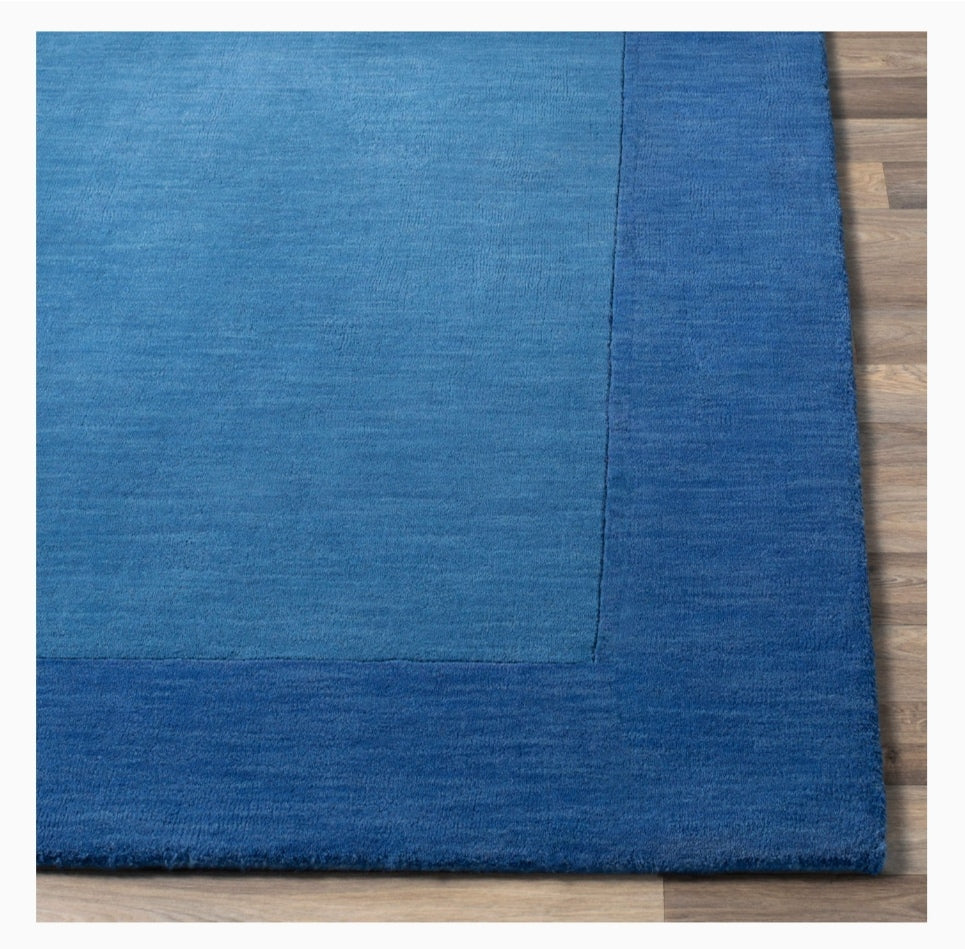 Blue rug on a wooden floor
