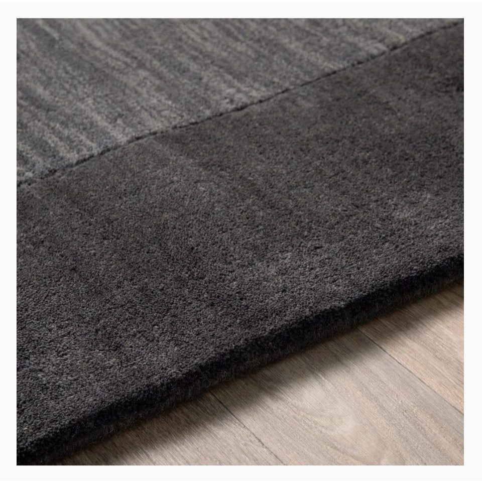 Dark gray rug on a wooden floor