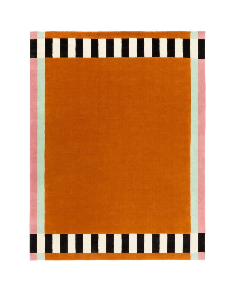 Orange handmade rug with black, white, and pink striped borders on a white background