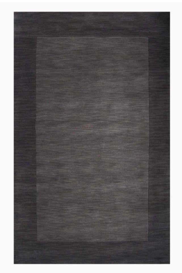 Rectangular dark gray rug on a white background
