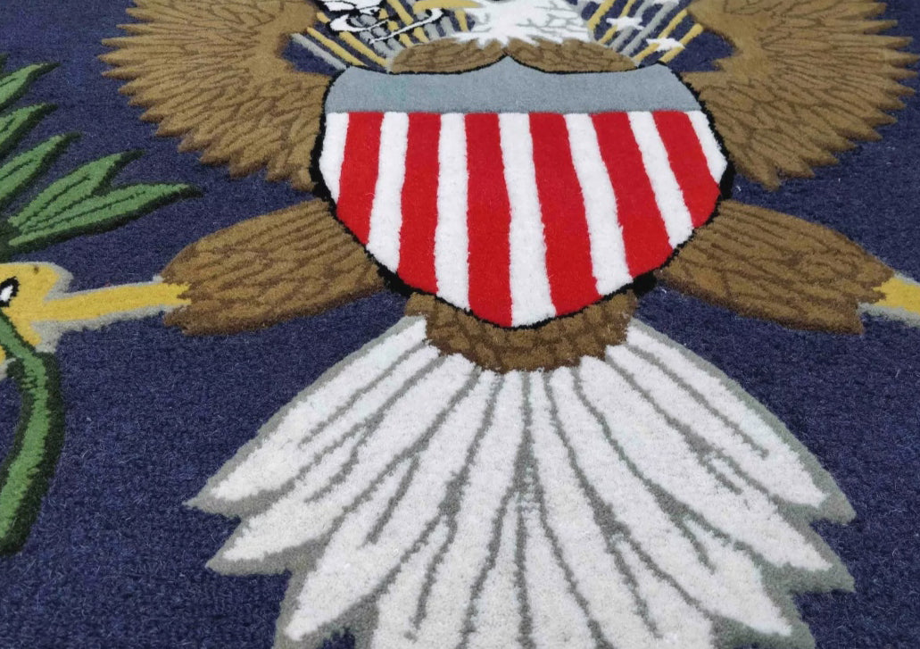 Close-up of a textured, high-pile tufted rug featuring the Great Seal of the United States.
