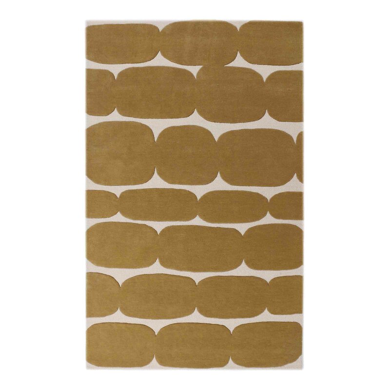 Hand-tufted wool rug with mustard oval pattern on ivory background
