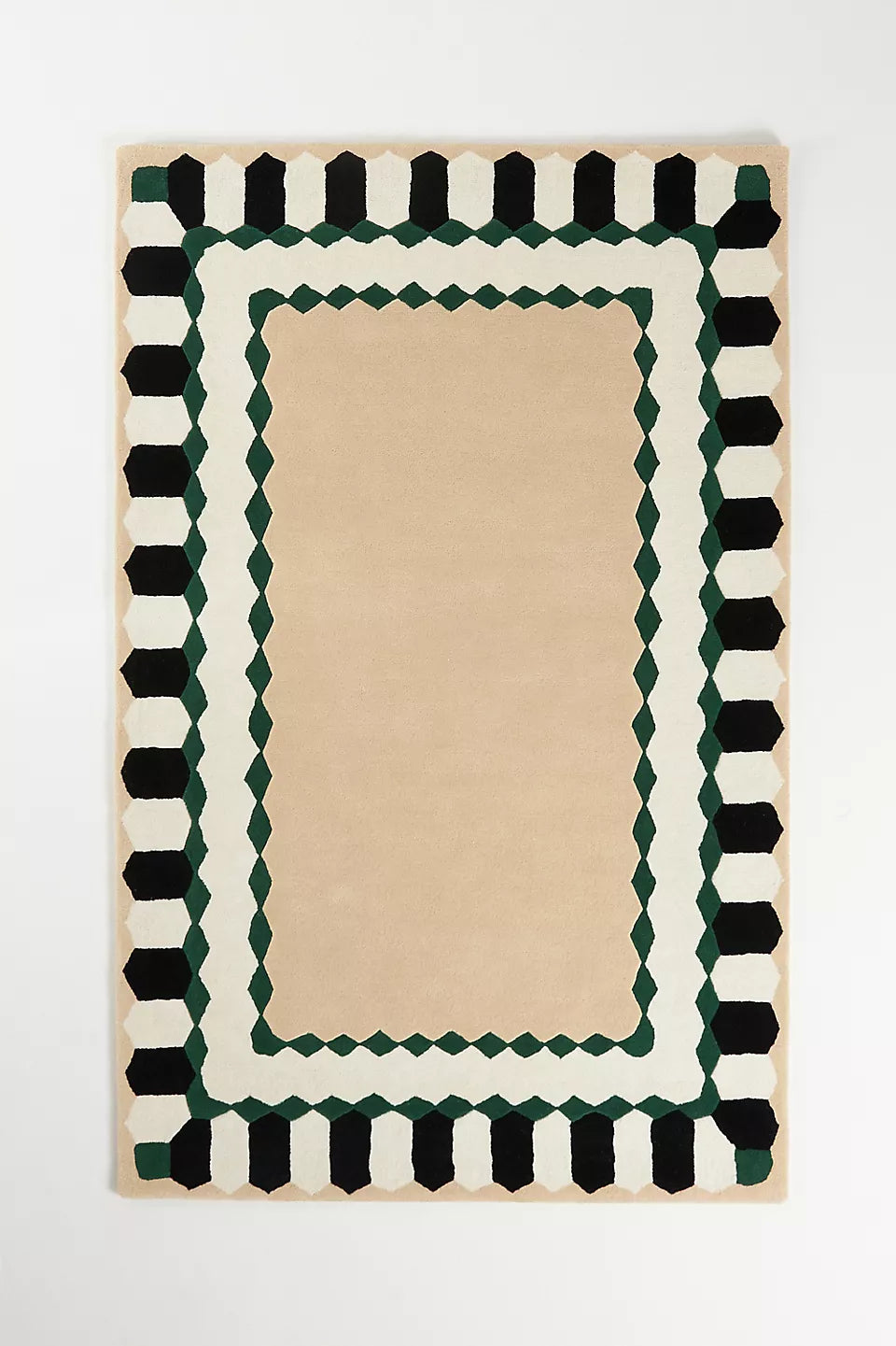 Hand-tufted beige wool rug with black, white, and green double geometric border