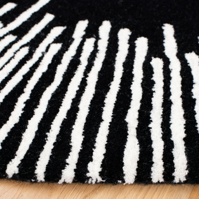 Close-up of a black and white striped rug on a wooden floor