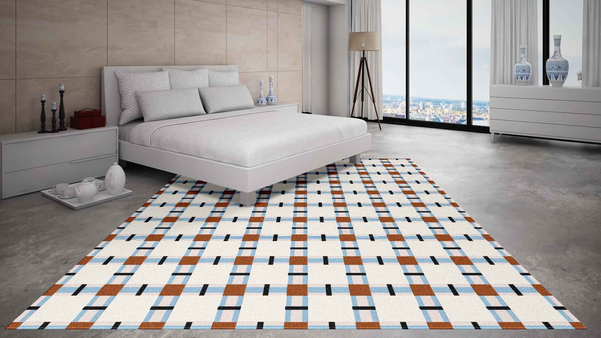 Patterned hand-tufted wool rug on a bedroom floor with a bed and decor in the background