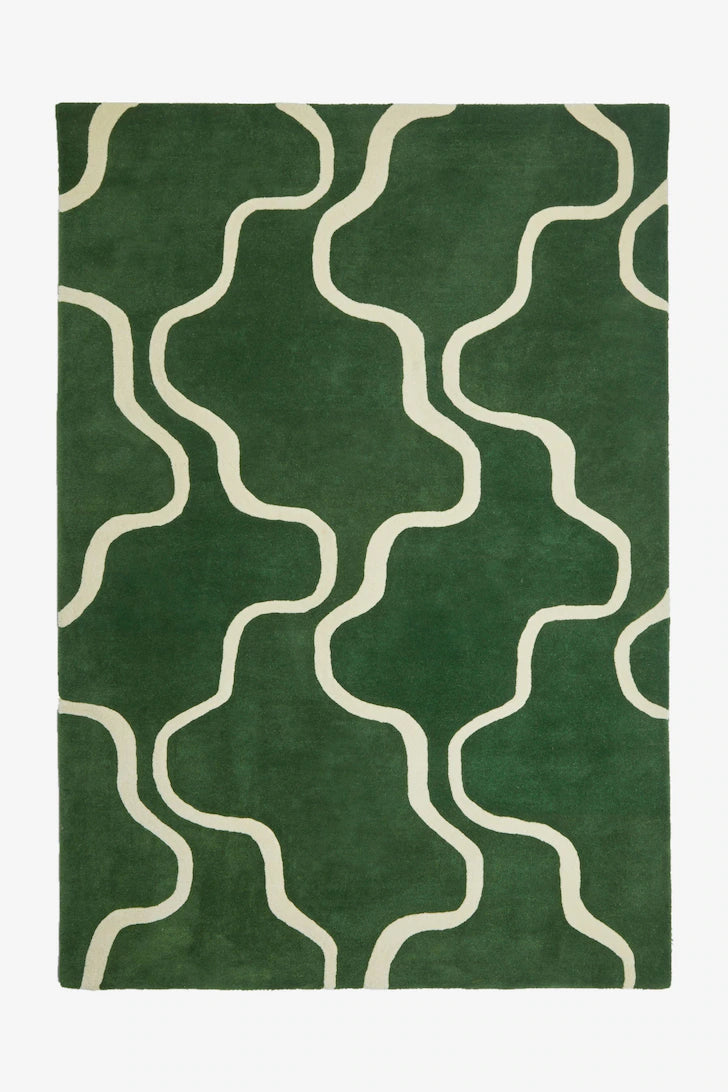 Green rug with white wavy patterns on a white background