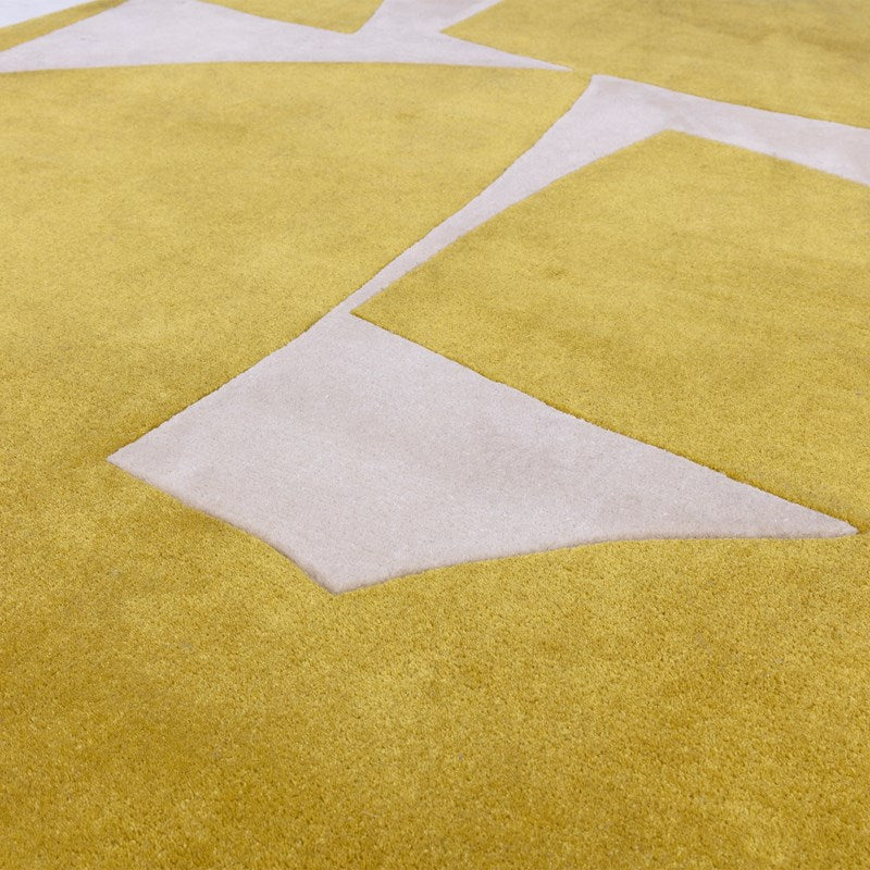 Close-up of a mustard yellow and white geometric patterned rug