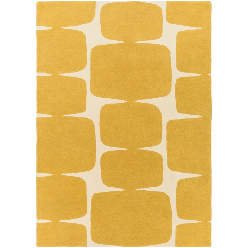 Yellow and white geometric patterned rug on a white background