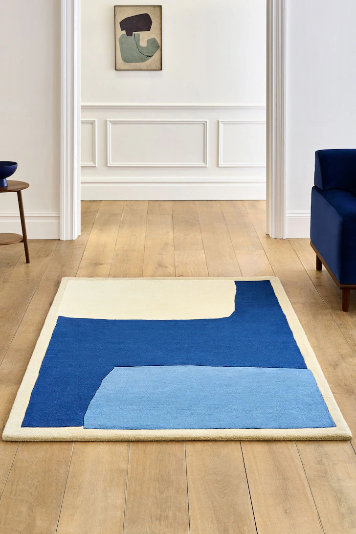 Hand-tufted wool rug with blue, navy, and ivory abstract color-block pattern