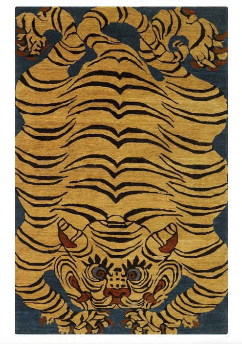 hand-tufted rug with tiger design on a blue background