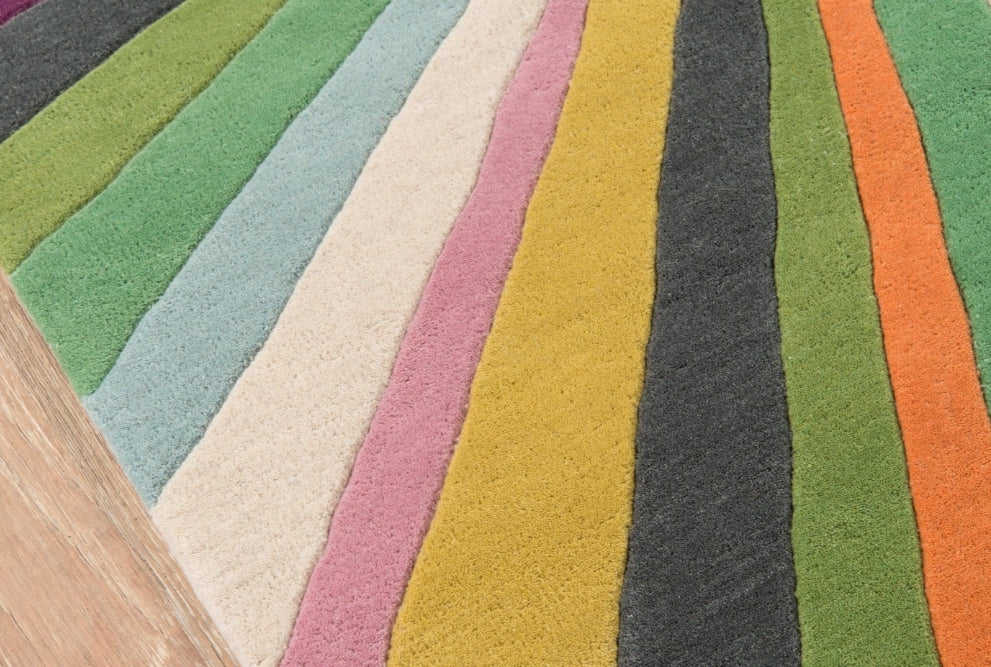 Multicolored striped rug on a wooden floor