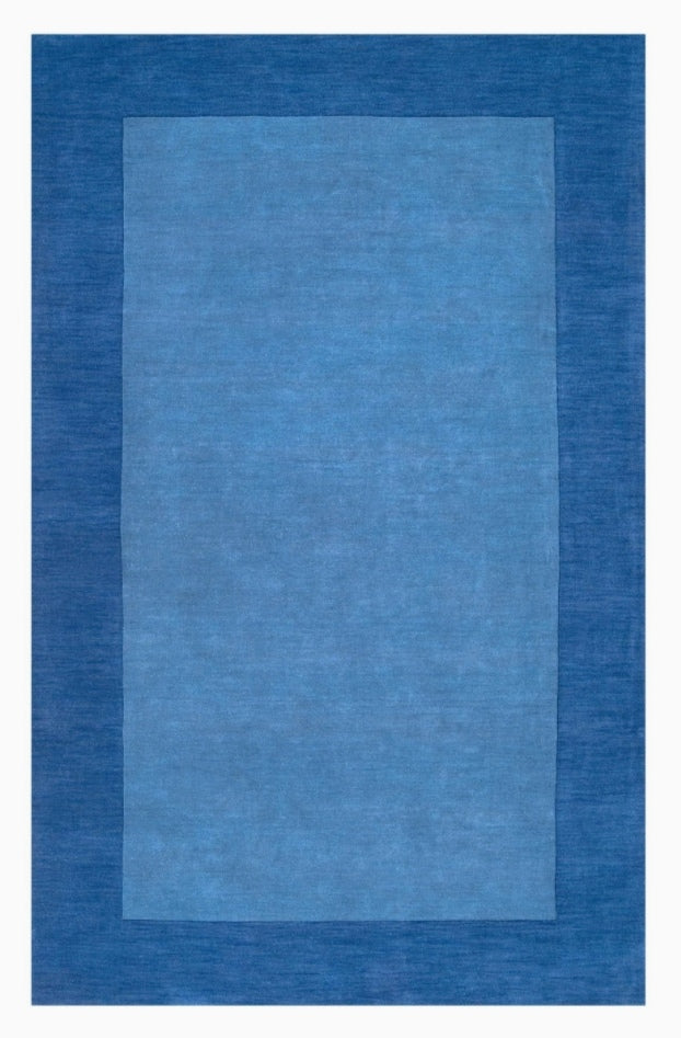 Solid blue area rug with a two-tone design featuring a light cerulean center and a darker royal blue rectangular border.