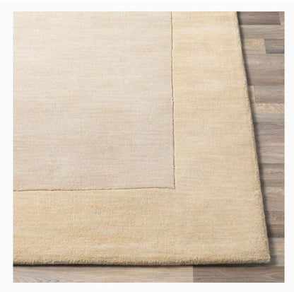 Solid Beige rug on a wooden floor