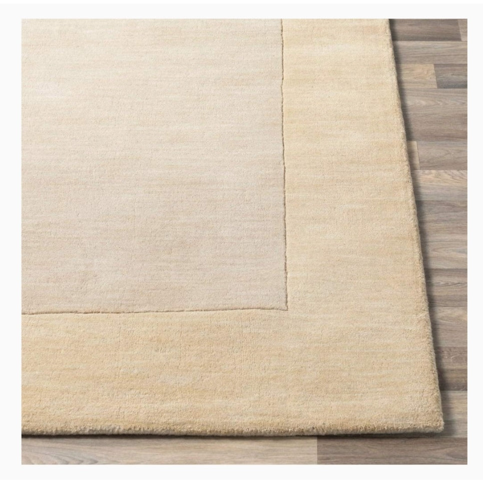 Solid Beige rug on a wooden floor