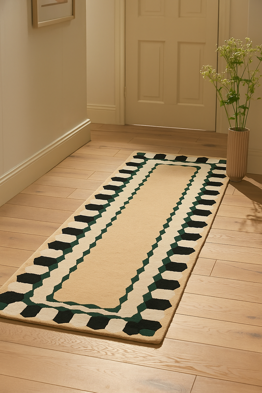 Hand-tufted beige wool runner rug with green geometric border in hallway
