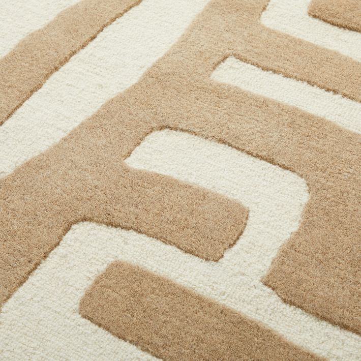 Close-up of a beige and white geometric patterned rug