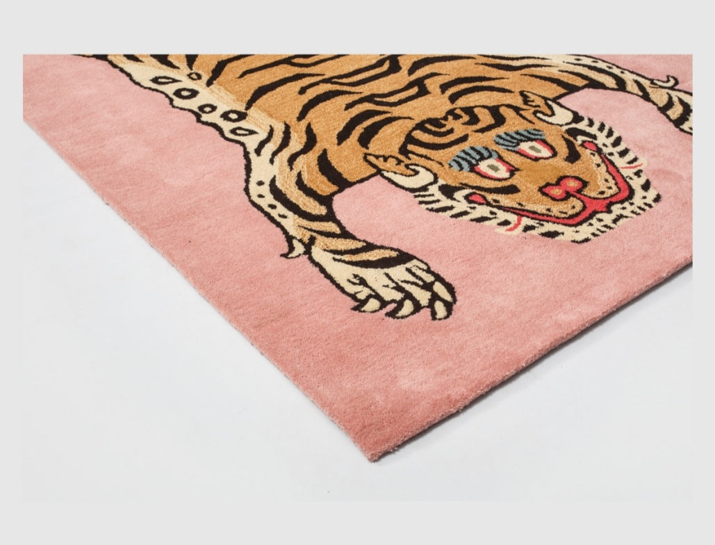 Pink rug with a tiger design on a white background