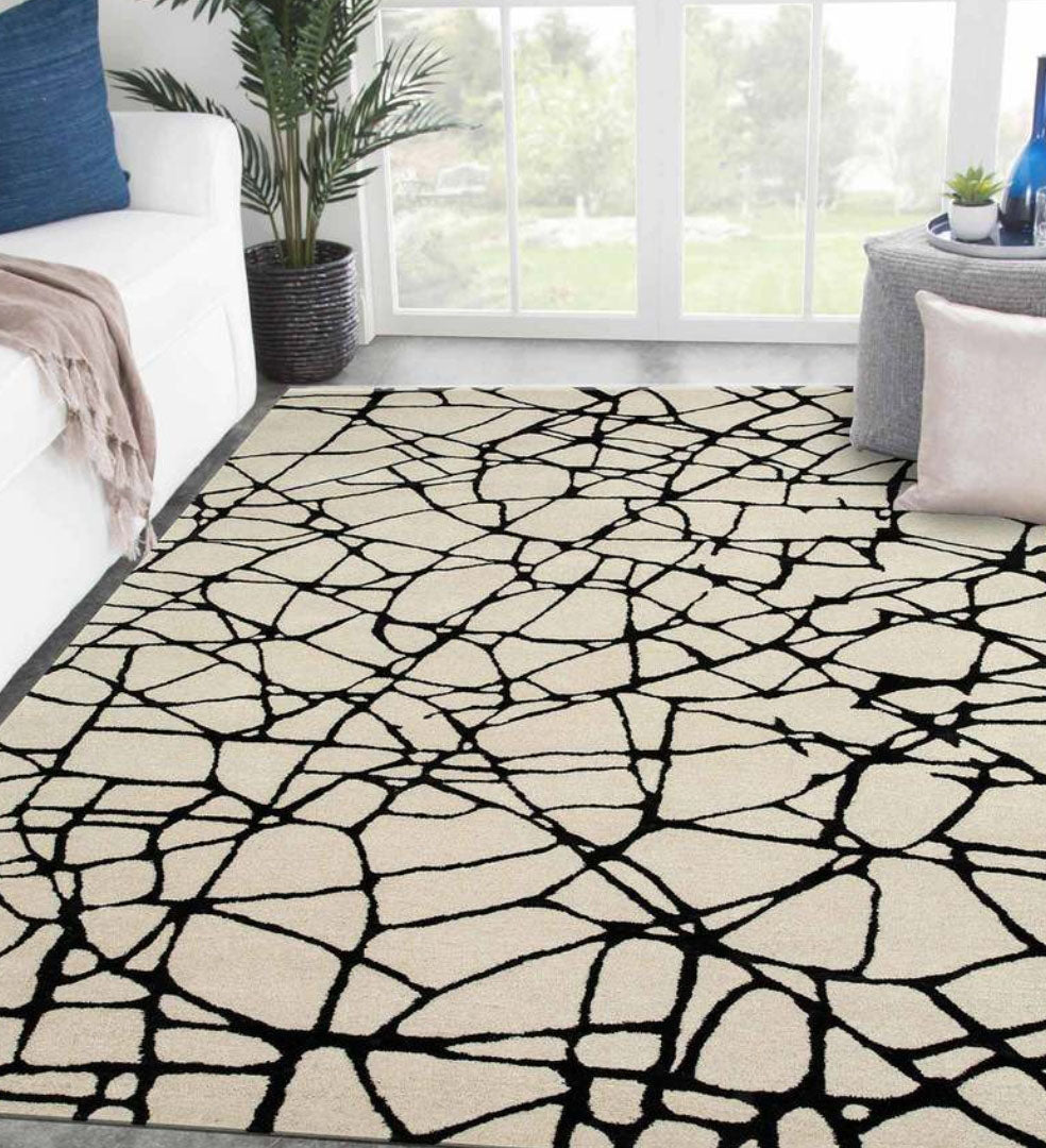 Black and white hand-tufted wool rug with abstract cracked line pattern