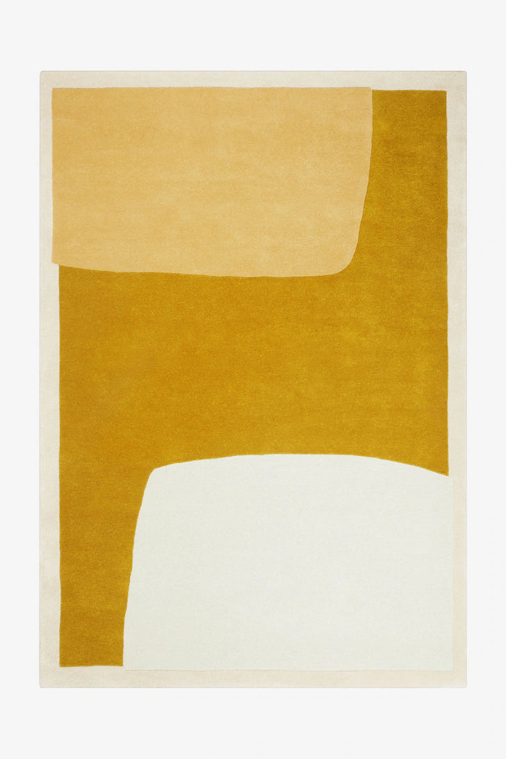 Rug with abstract design in mustard yellow and white on a beige background