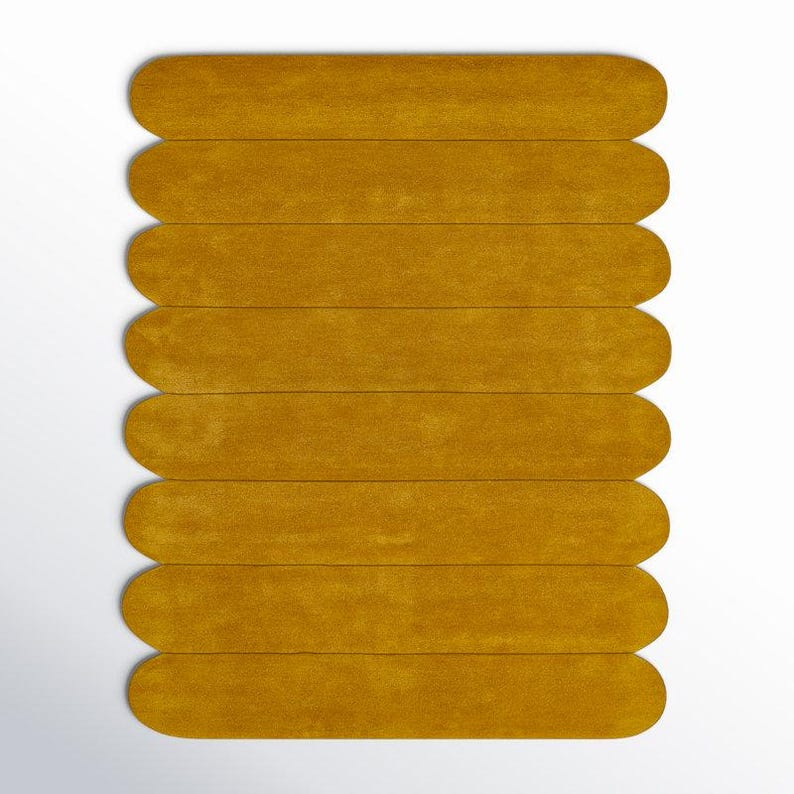 Mustard yellow hand-tufted wool rug made of eight horizontal oval segments in a sculptural geometric layout.