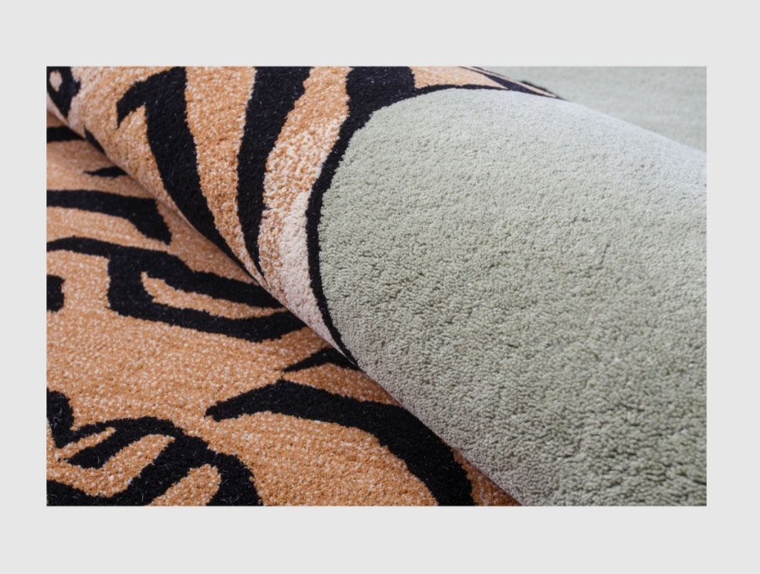 Close-up of a carpet with tiger stripe pattern and plain gray section