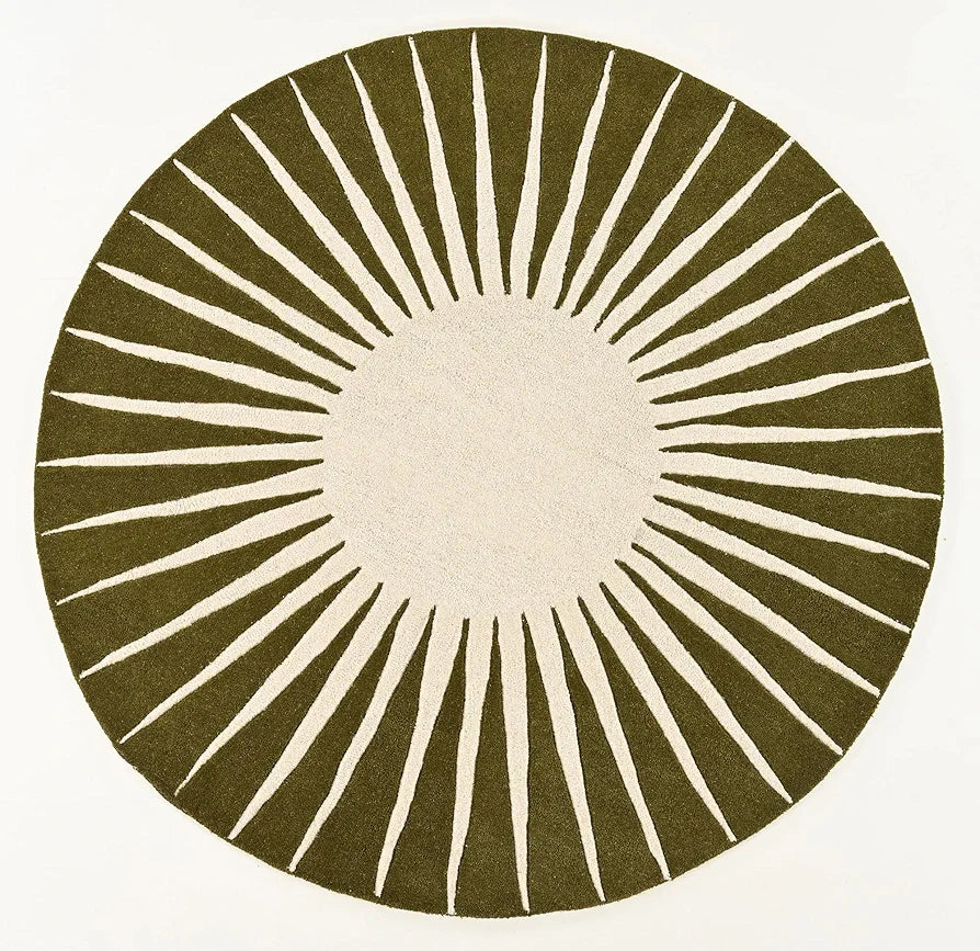 Round hand tufted rug with sunburst pattern on a white background