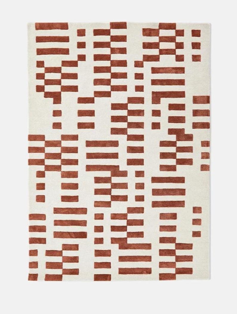 Hand-tufted modern wool rug with abstract brick pattern in rust red and cream