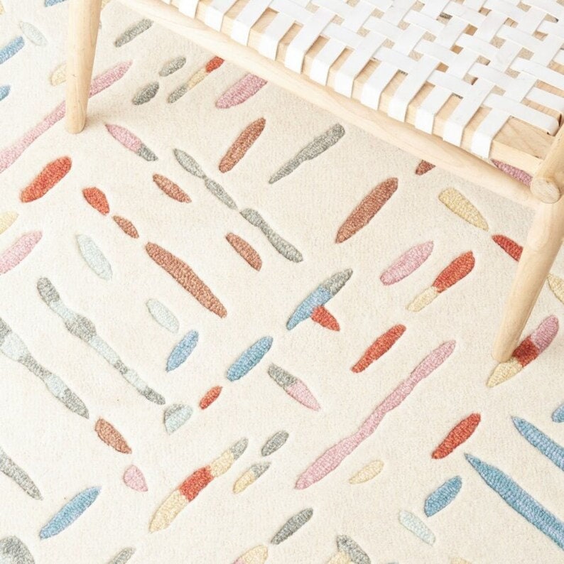 Patterned rug with colorful abstract designs on a neutral background