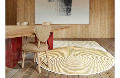 Minimalist half-circle hand-tufted wool rug in cream and golden beige with modern geometric texture