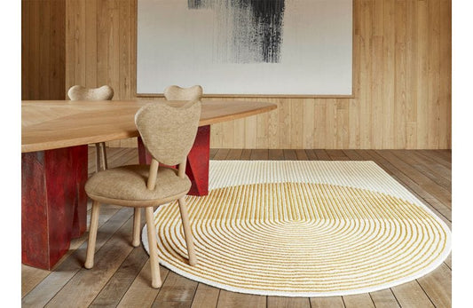 Minimalist half-circle hand-tufted wool rug in cream and golden beige with modern geometric texture