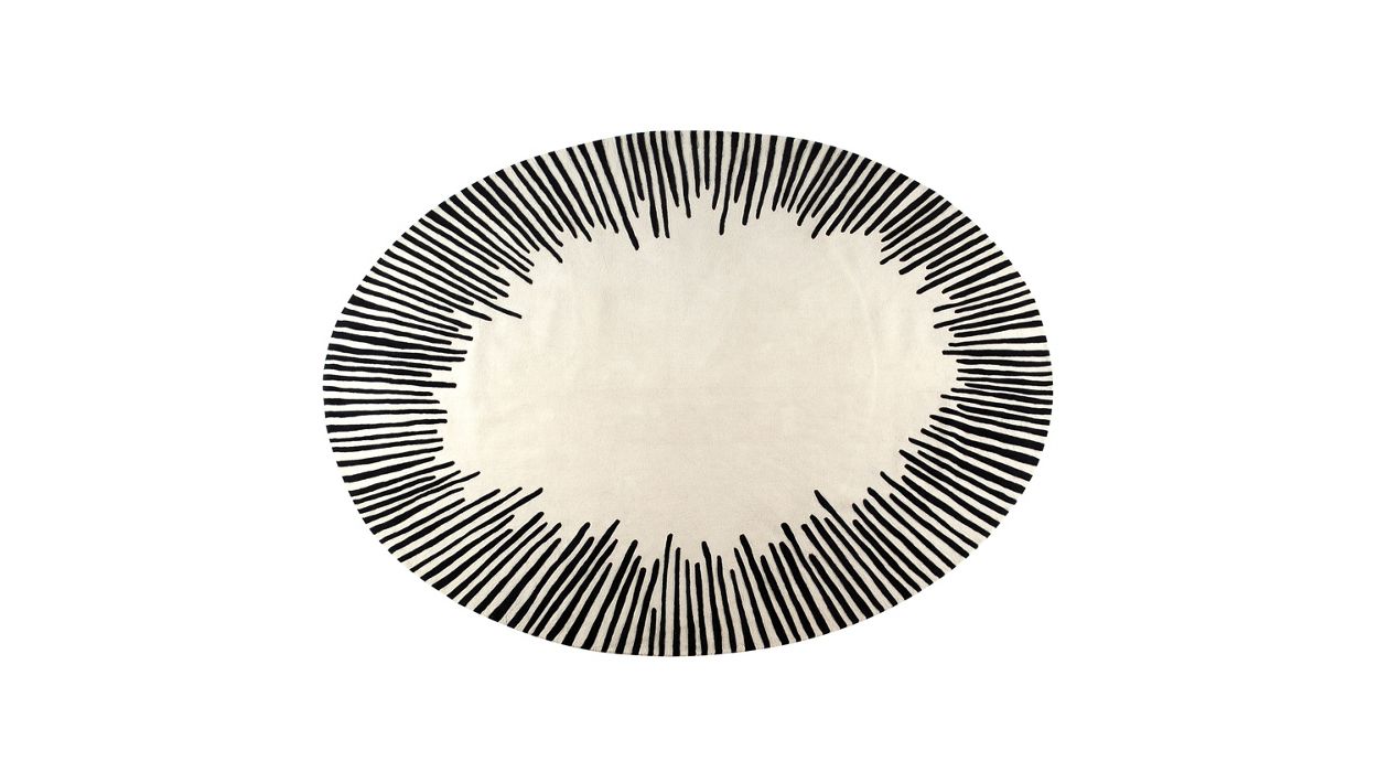 Hand-tufted Modern Oval Cream Rug featuring a black sunburst design, crafted from handmade wool
