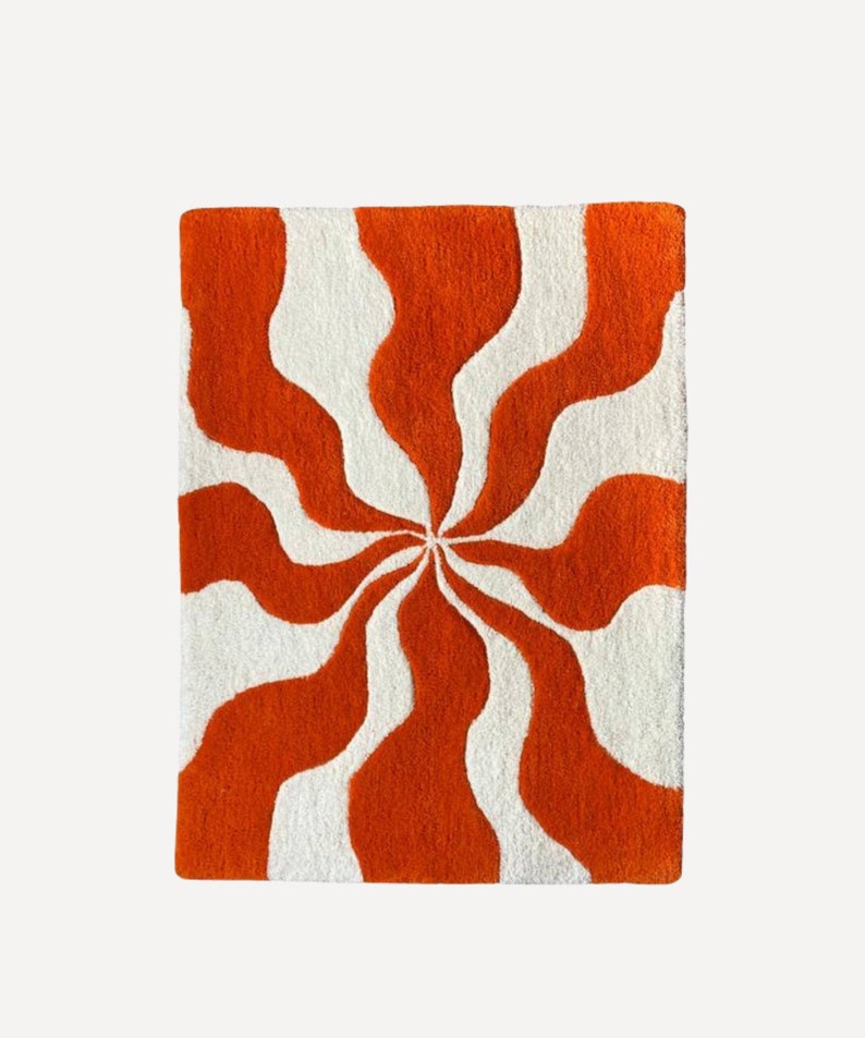Rug with red and white wavy pattern on a white background