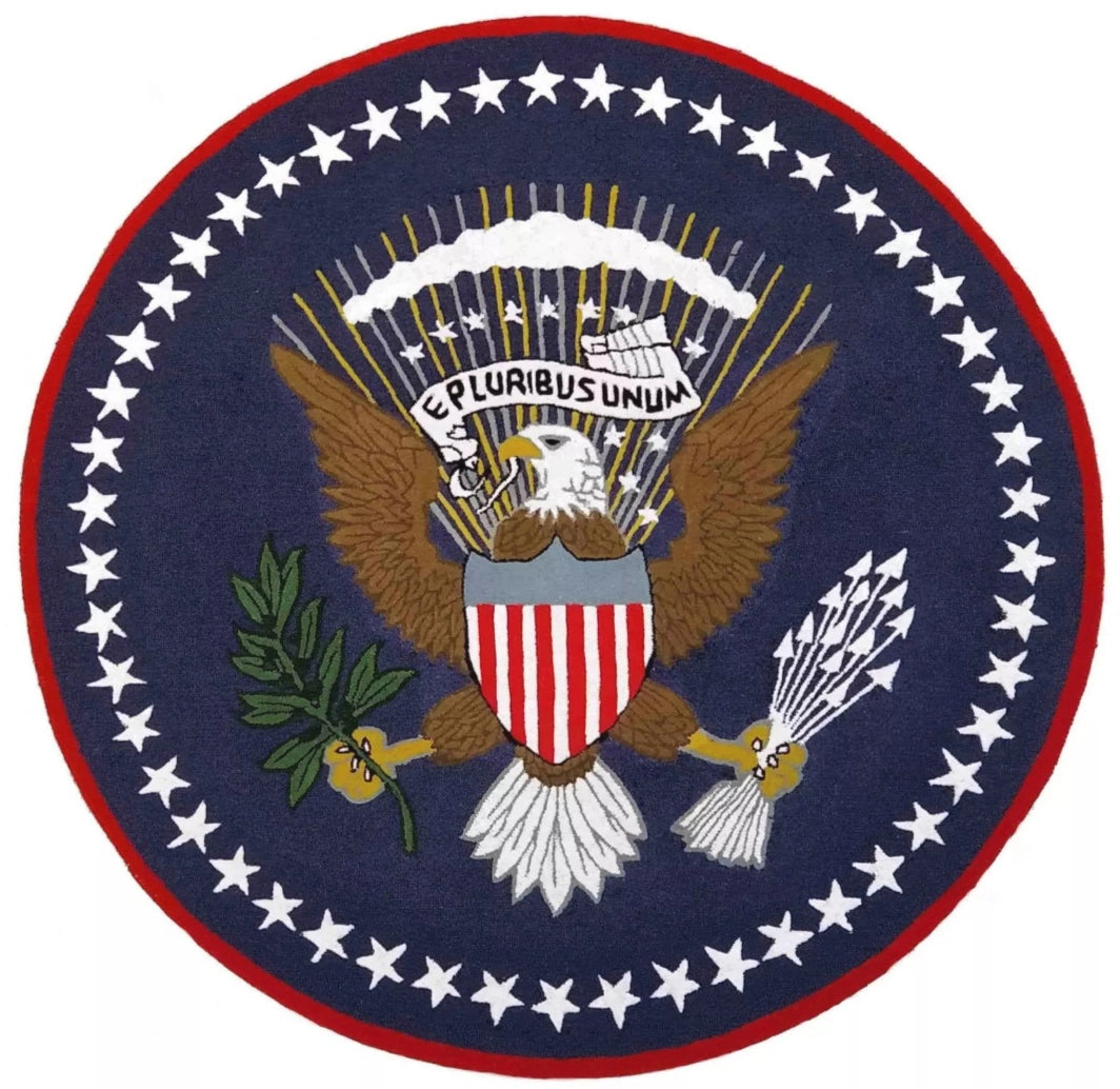 Round hand-tufted wool rug featuring the United States Presidential Seal with the bald eagle, stars, and "E Pluribus Unum" on a deep navy background.