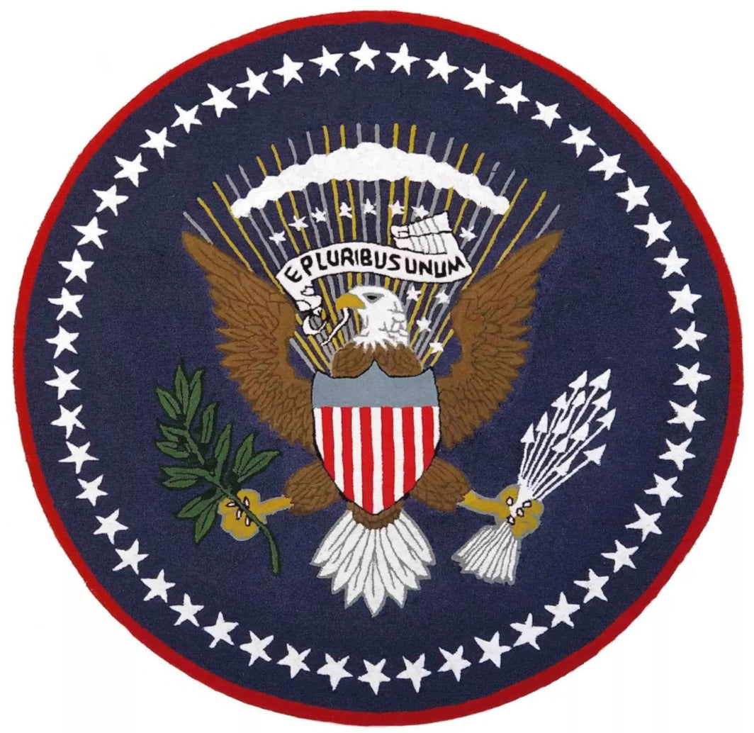Seal of the President of the United States with an eagle, shield, and stars on a blue background.