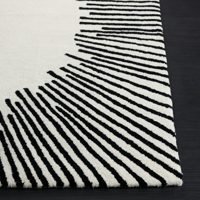 Black and white hand-tufted modern rug with radiant line pattern